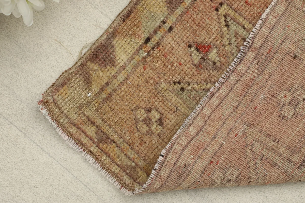 View of the rug folded to show the thickness and the backside of the hand-knotted cotton foundation.