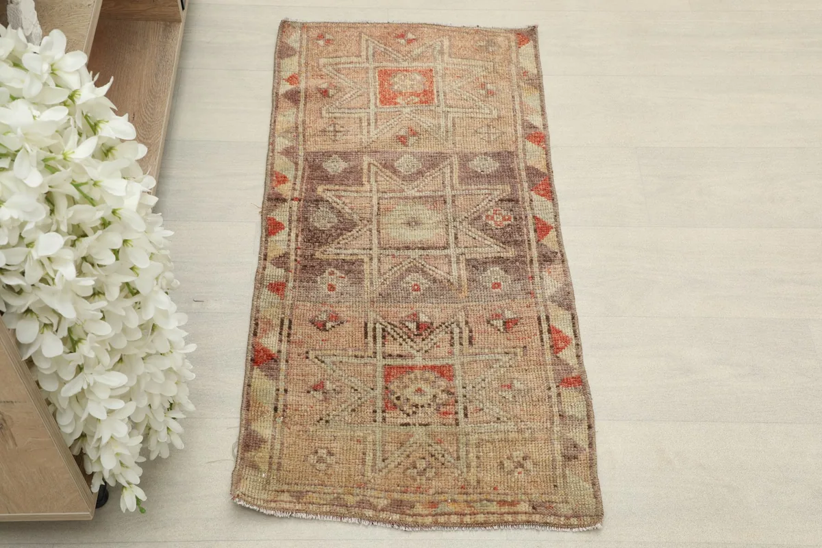 Overhead view of the vintage doormat showcasing its full geometric pattern and colors.