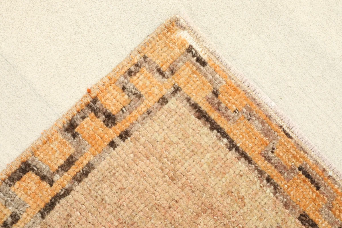 Corner close-up highlighting the orange border with its distinctive geometric step pattern.