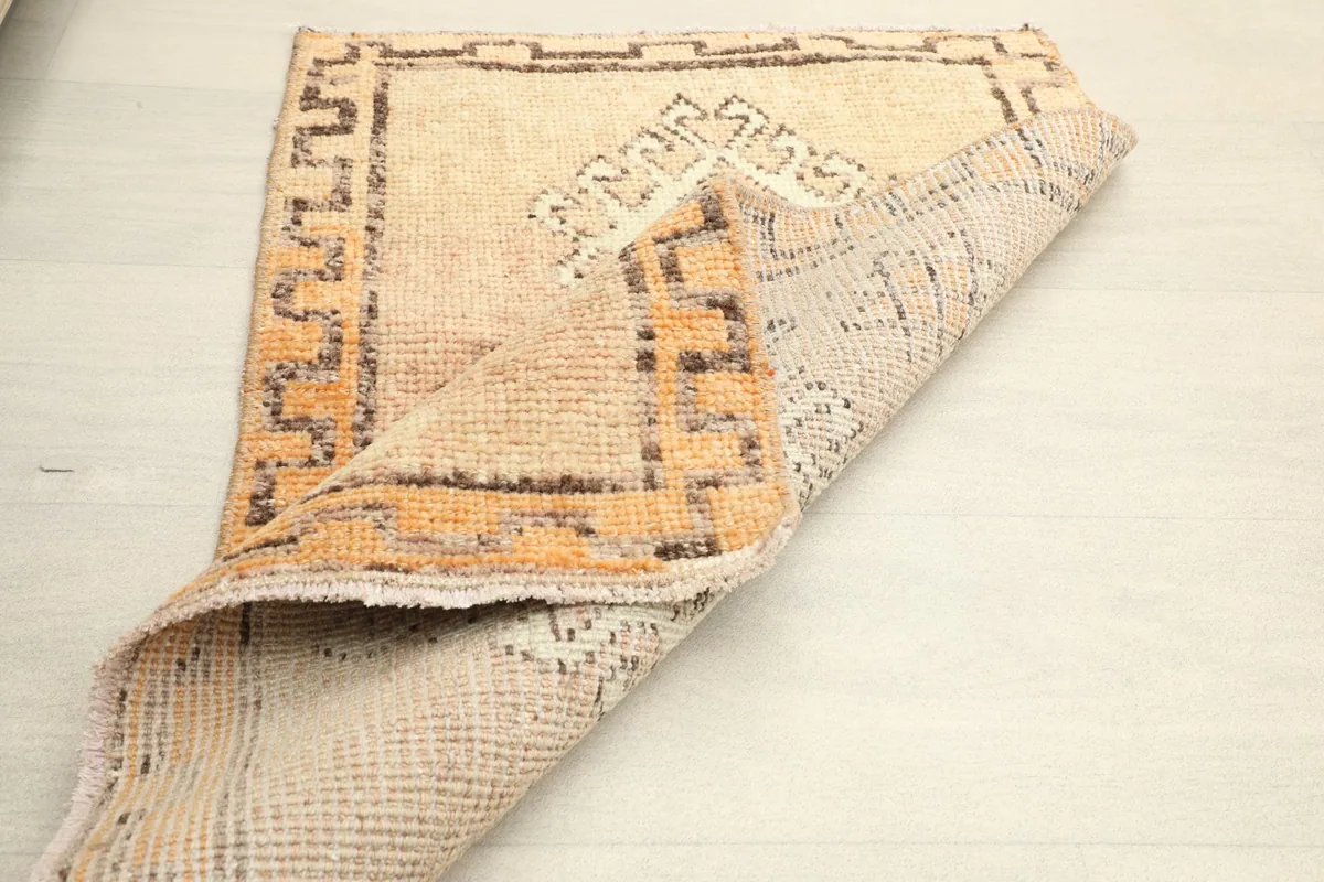 Another folded view, revealing the hand-knotted construction and the back of the rug.