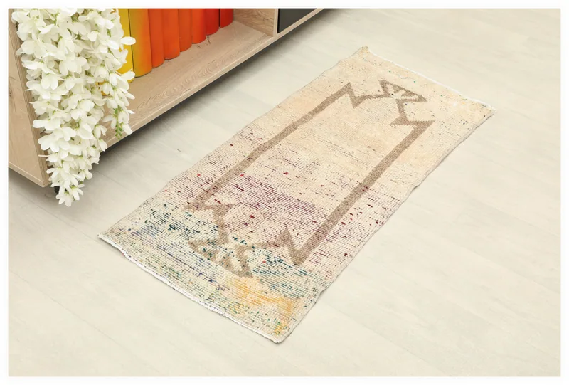 Full top view of the 1'7" x 3'6" ivory geometric prayer rug on a white background.