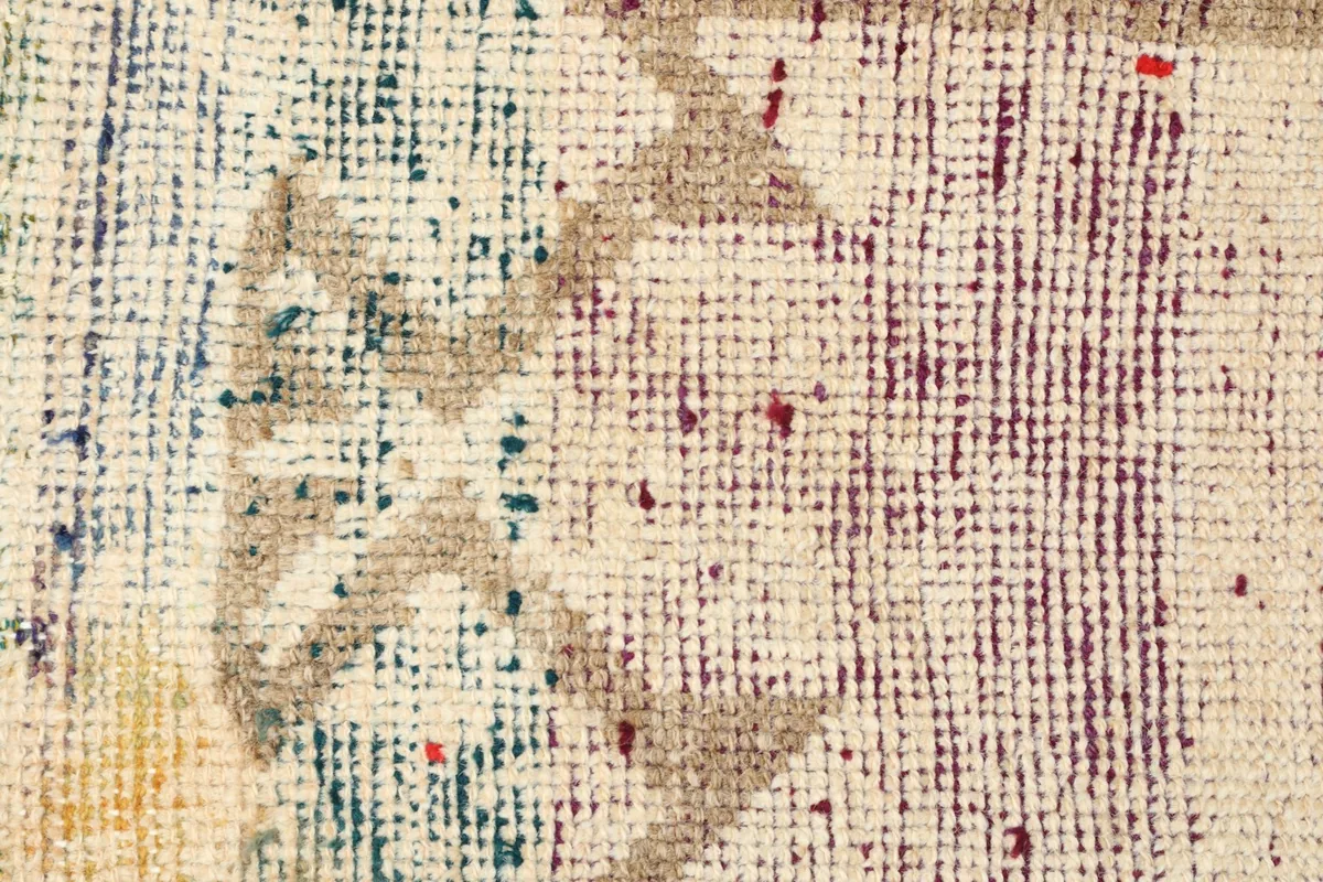 Detailed view of the distressed multicolor section, showcasing faded red, blue, green, and yellow tones.