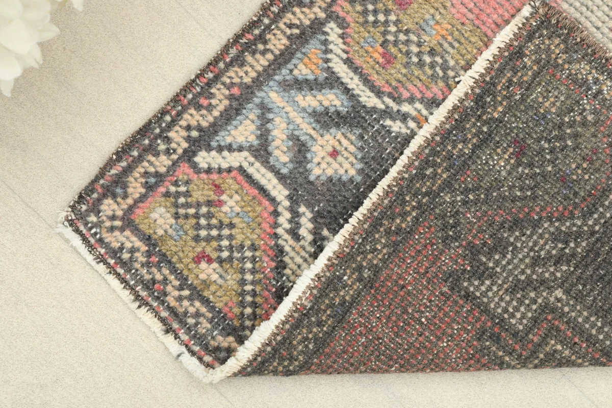 The vintage rug folded to reveal the back of the hand-knotted cotton foundation and pile.