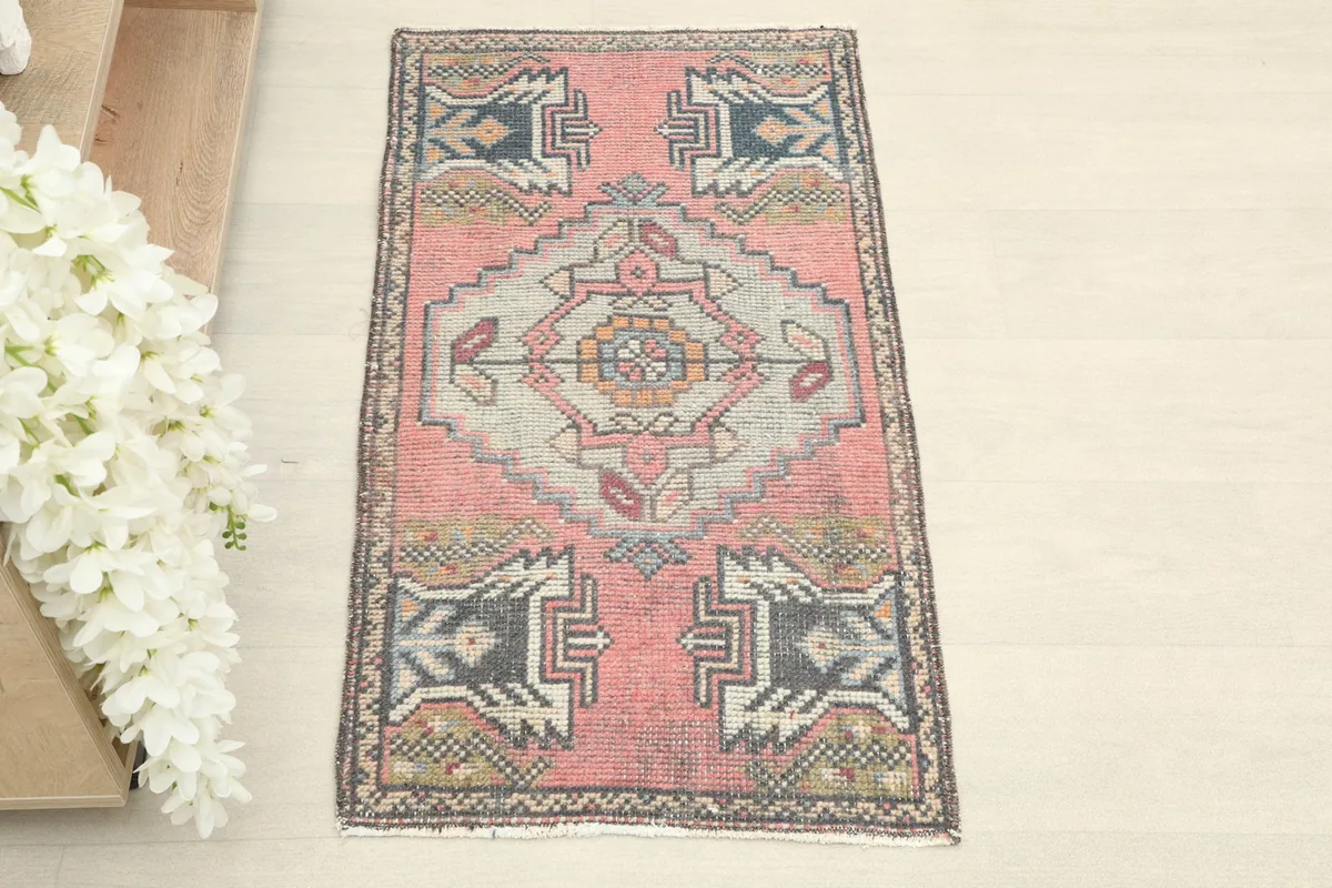 Straight overhead view of the hand-knotted rose area rug, showing the full pattern and colors.