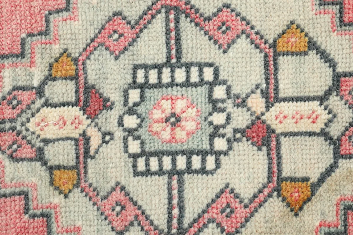 Detailed view of the intricate hand-knotted patterns within the medallion.