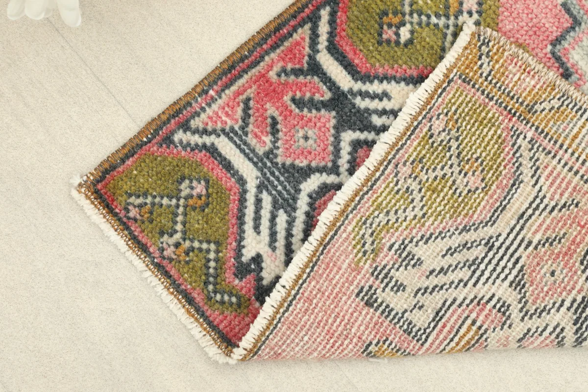View of the back of the rug, showing the cotton foundation and hand-knotted construction.