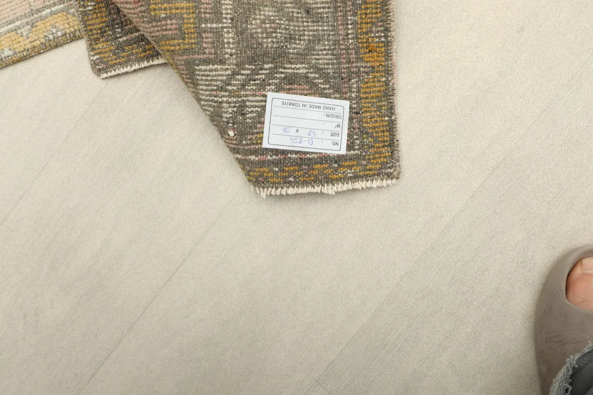 Close-up of the rug's back side and a product tag, indicating its origin and materials