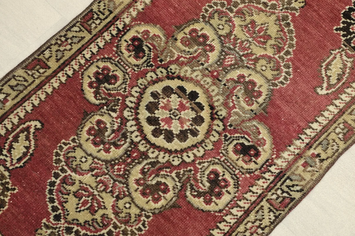 Close-up detail of the central medallion and surrounding paisley elements on the rose field