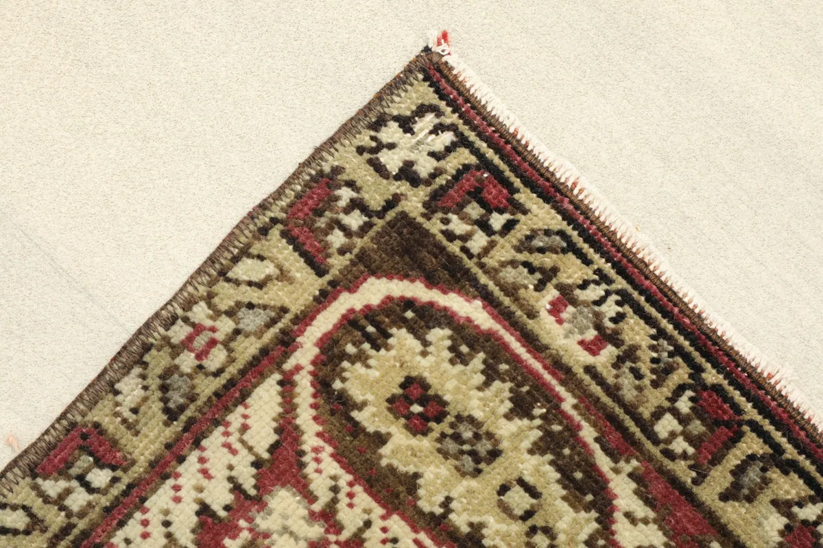 Corner view showing the back of the rug, revealing the cotton foundation and hand-knotted construction