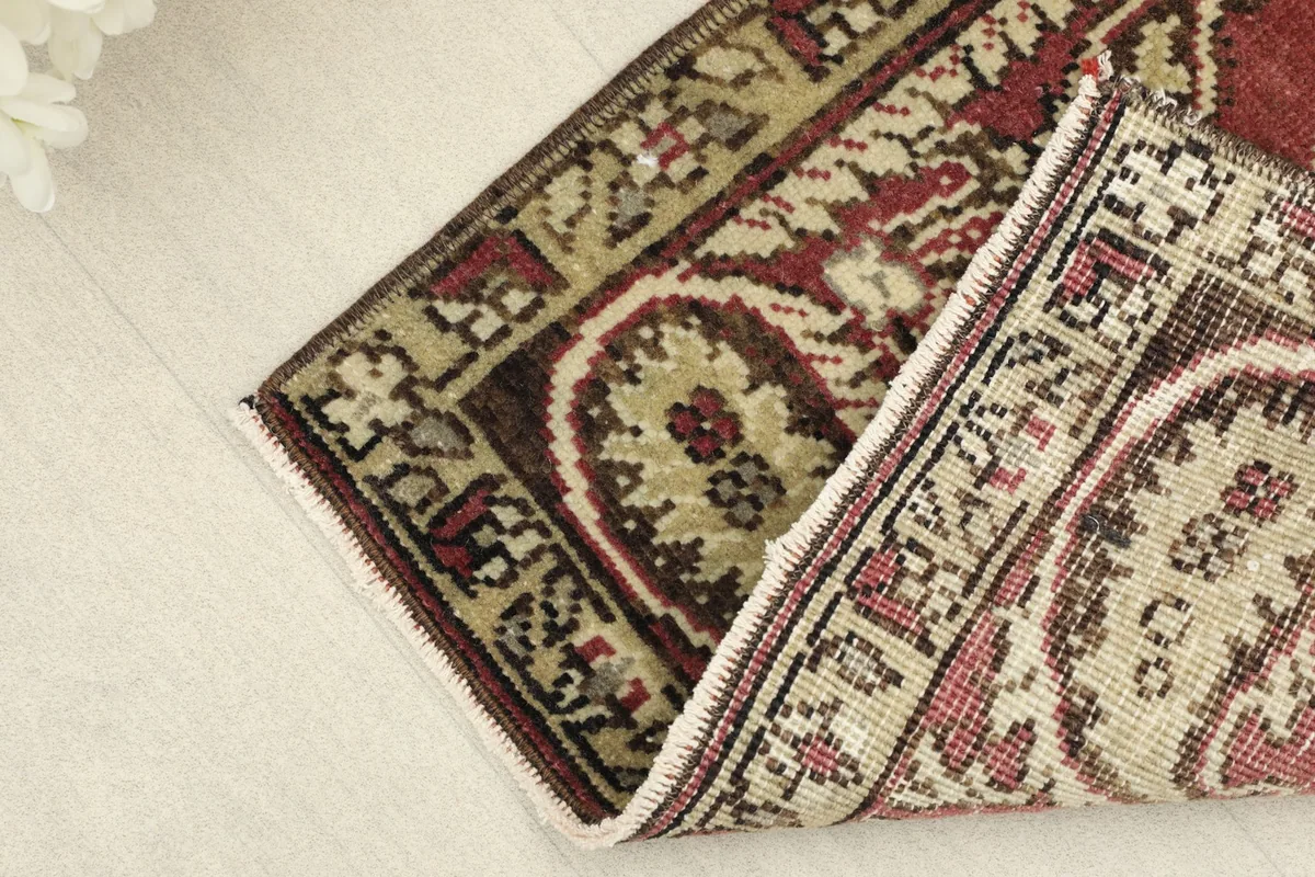Angled view of the rug folded at a corner, showcasing its texture and border details