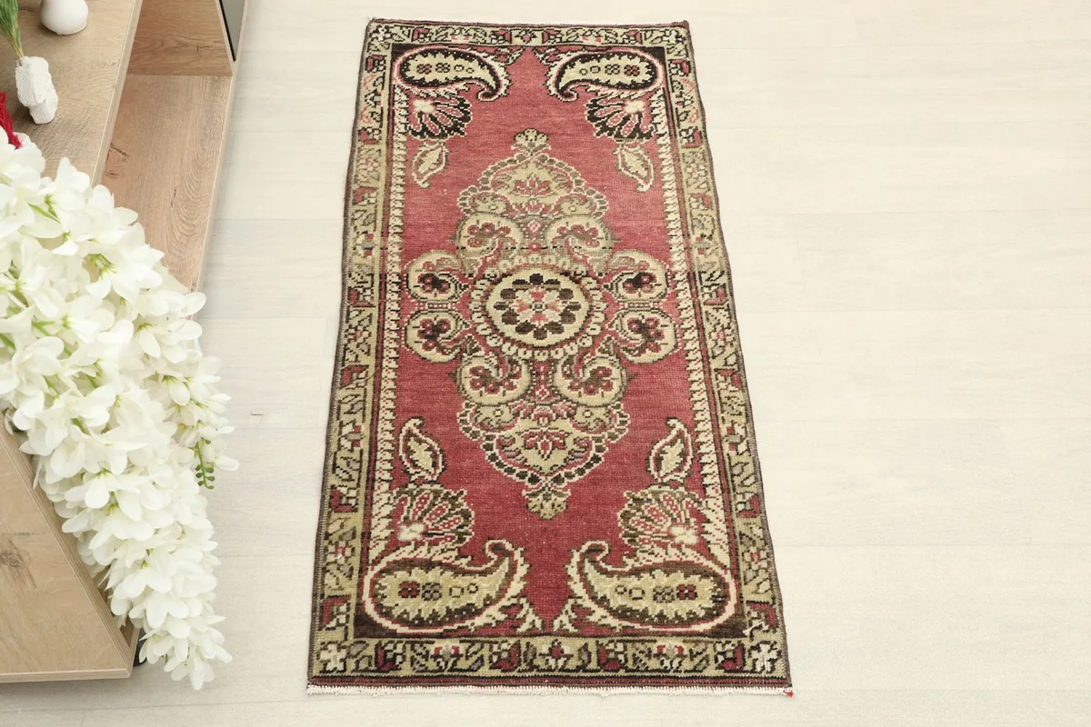 Overhead view of the hand-knotted rose rug, showing the full design and colors