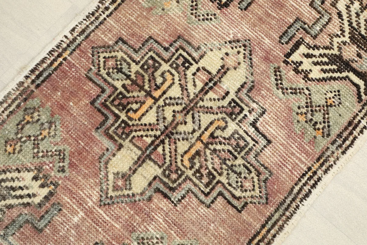 Angled view showcasing the central geometric medallion and rose field of the rug.