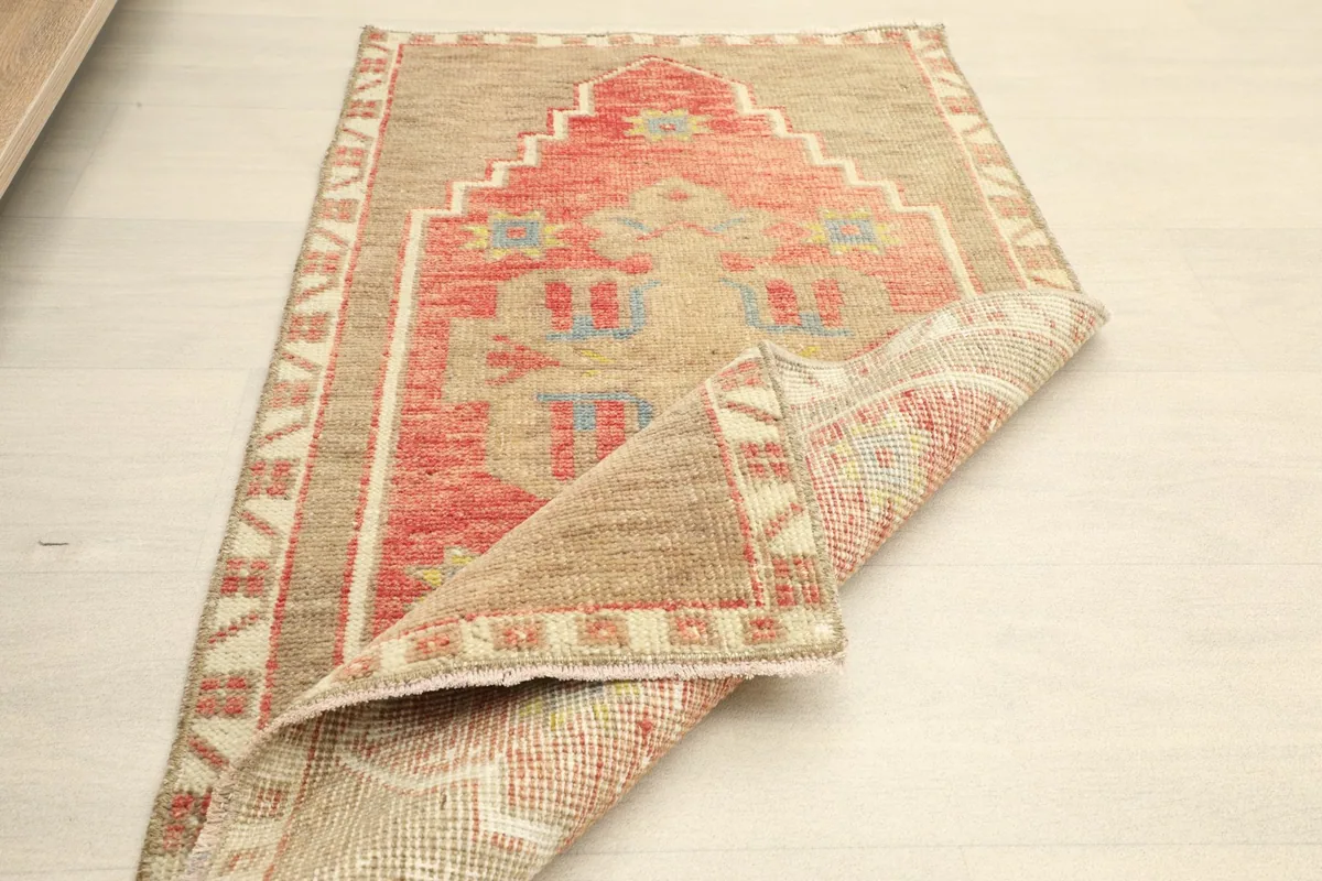 Angled view of the rug partially folded, showcasing its flexibility and the overall design.