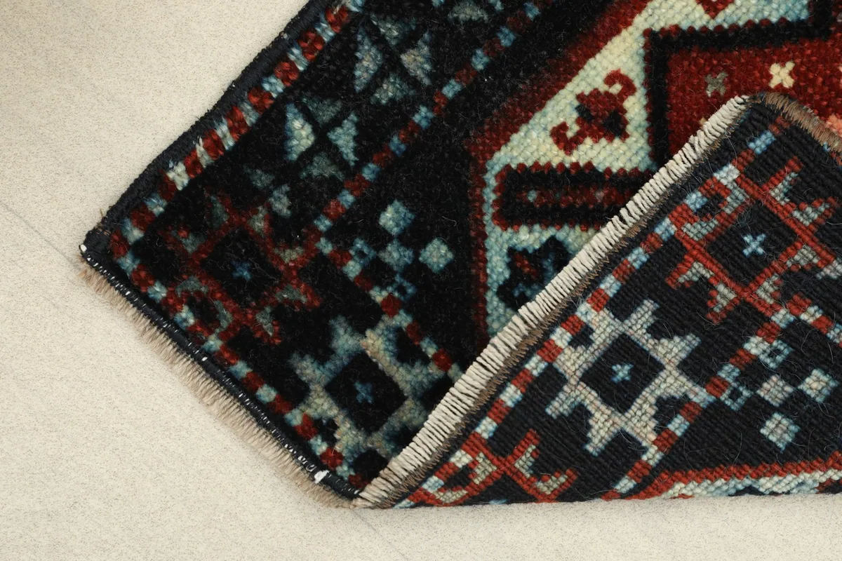 The rug folded to reveal the thickness of the hand-knotted wool and cotton foundation