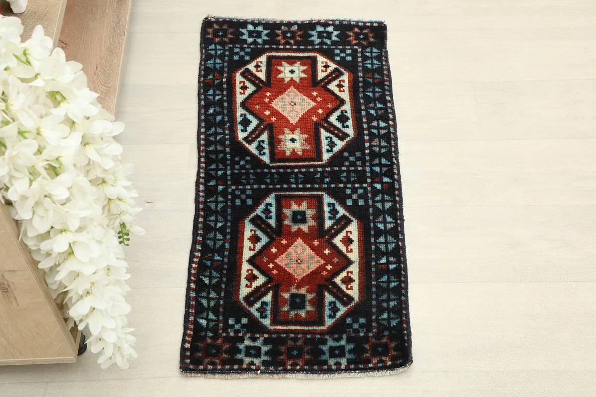 Overhead view of the small hand-knotted wool rug, showing its full design
