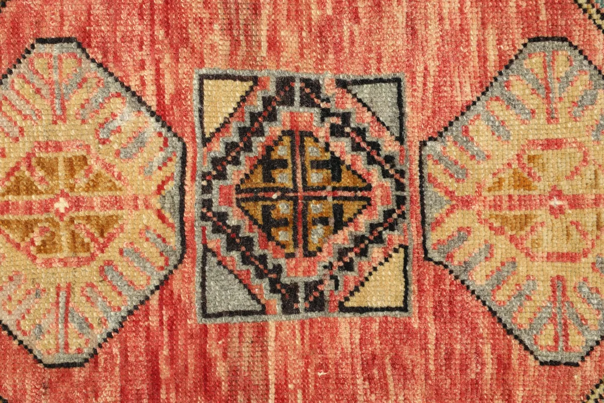 Macro detail of the central geometric medallion and surrounding patterns in the rose field.