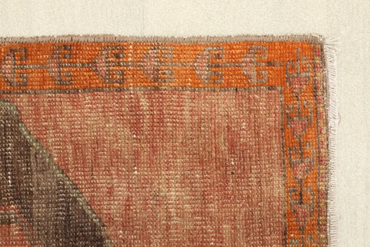 Detail of the vibrant orange border and the subtle patterns within it.