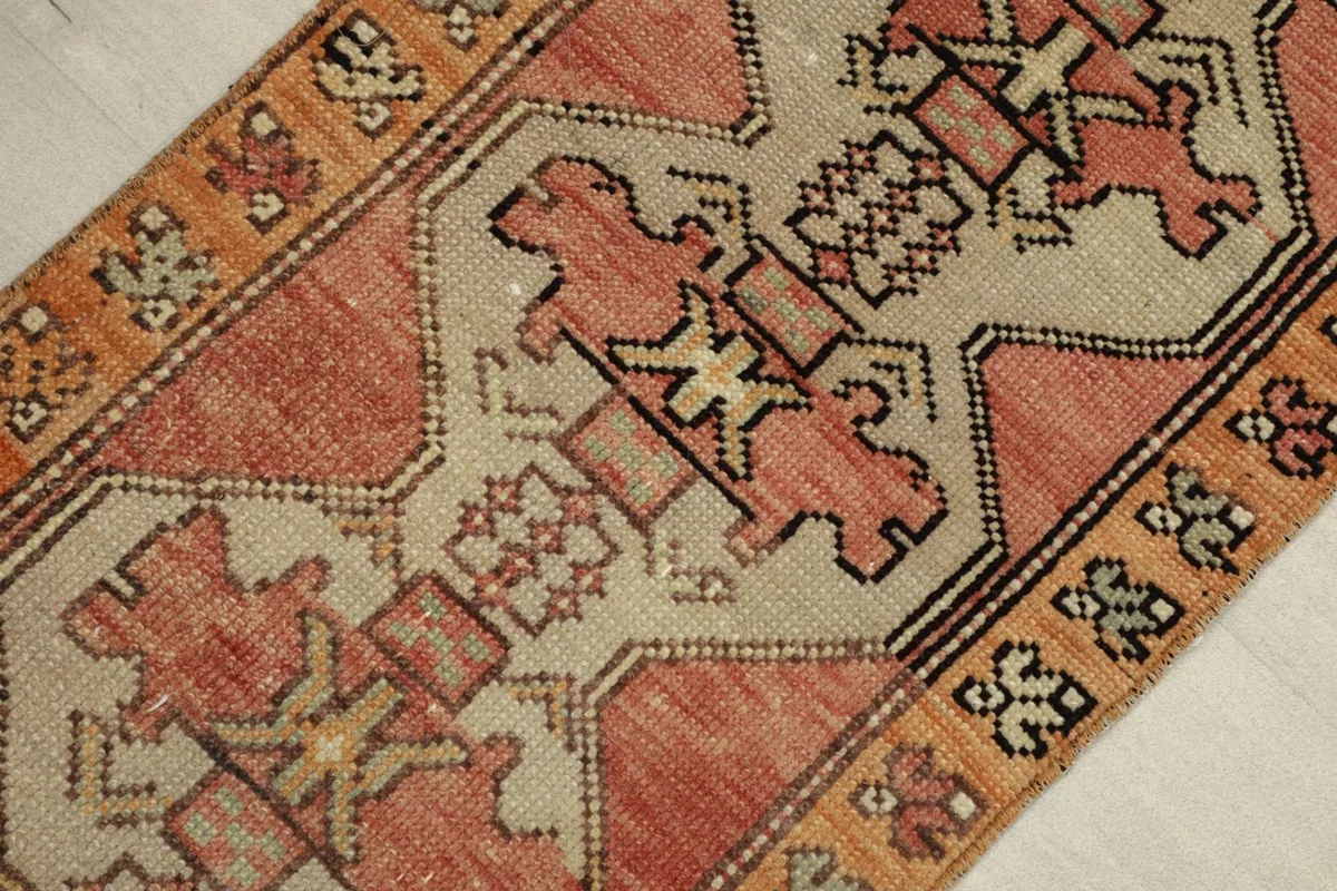 Angled view highlighting the tribal patterns and color variations within the hand-knotted wool pile.
