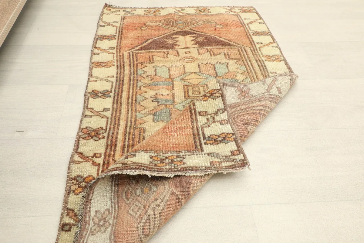 The rug partially folded to show the back and front texture, emphasizing its flexibility.