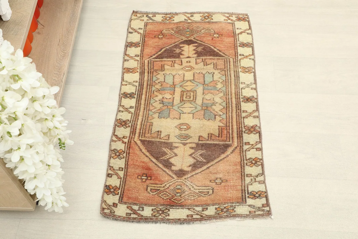 Overhead view of the hand-knotted wool doormat, showing its full design and colors.