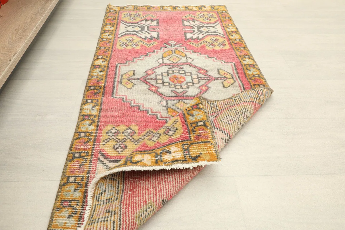 The rug partially folded, illustrating its flexibility and the overall design from an angle.