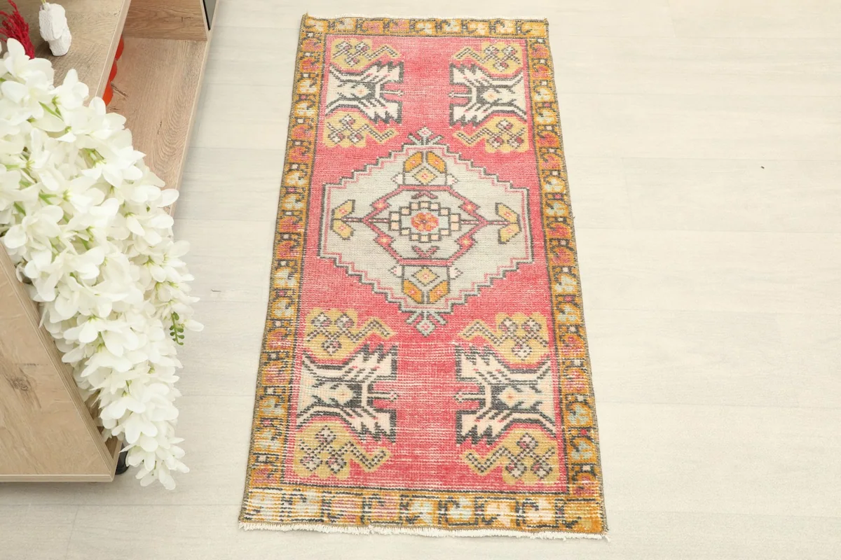 Straight overhead view of the full 1'7" x 3'6" hand-knotted wool doormat, showcasing its rose field and geometric design.