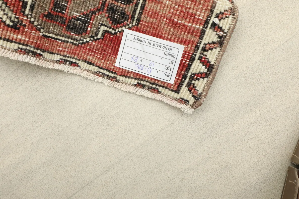 Close-up of the back of the rug, revealing the tight hand-knotted wool pile on its cotton foundation.