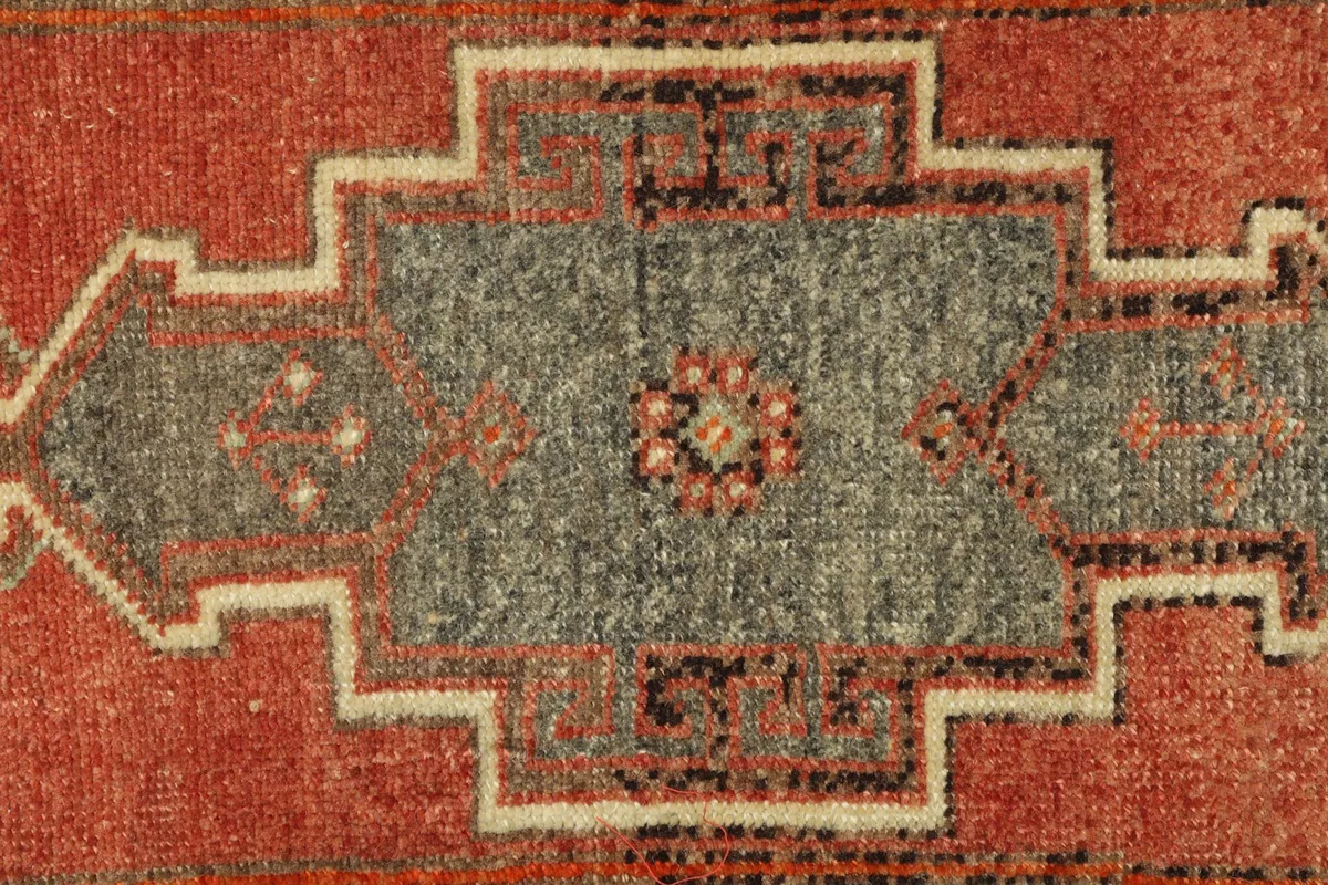 Tight detail shot highlighting the intricate knotting and color blend within the main pattern.