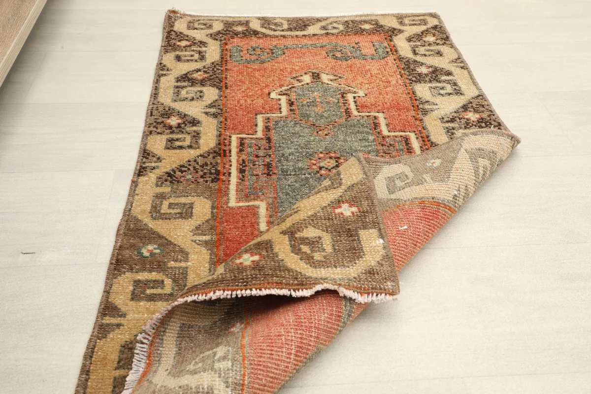 The rug partially folded, demonstrating its flexibility and the cotton foundation.