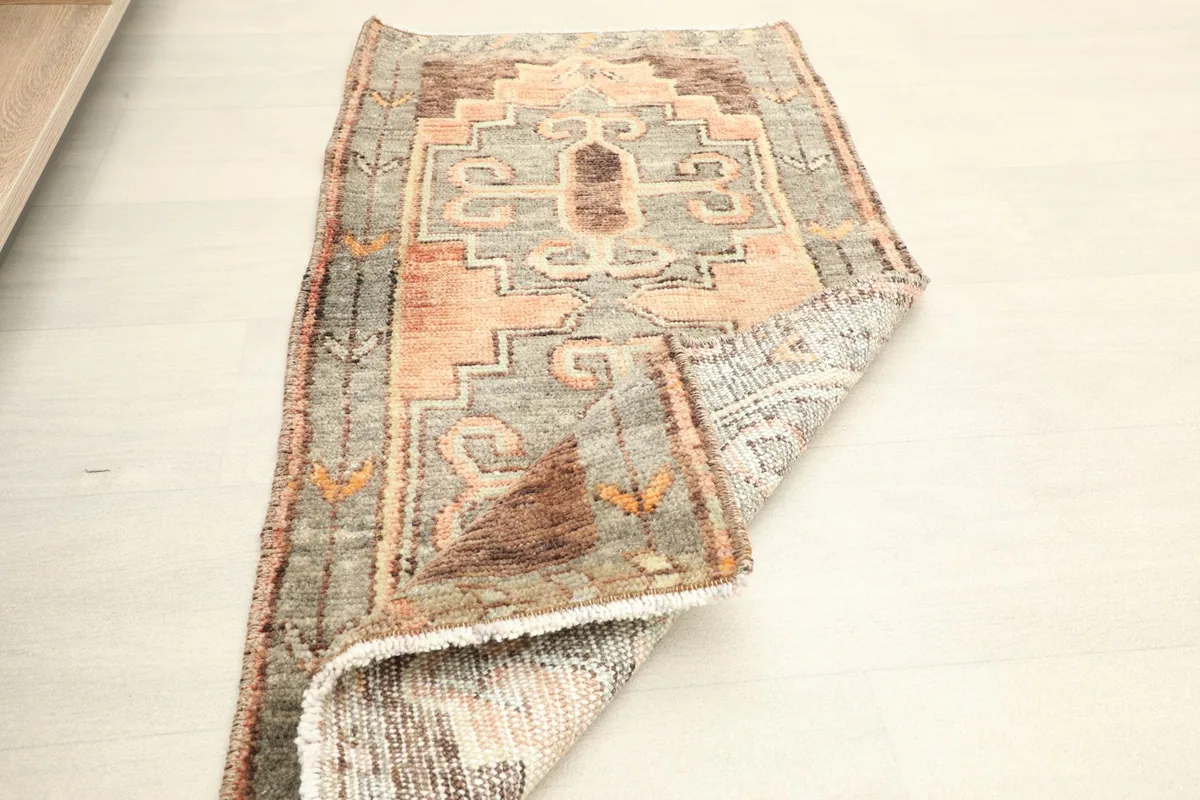 The rug partially folded, displaying both the top surface and a glimpse of the back.