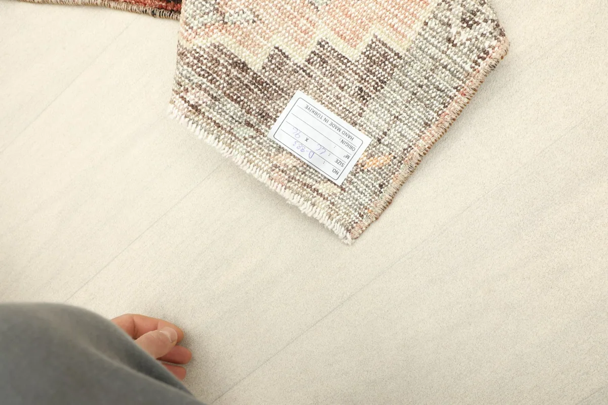 Close-up of the rug's label on the back, confirming its origin and materials.
