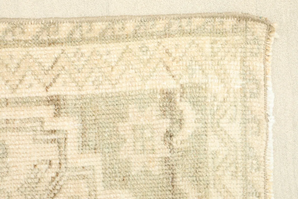Close-up of the low wool pile and the intricate hand-knotted construction.