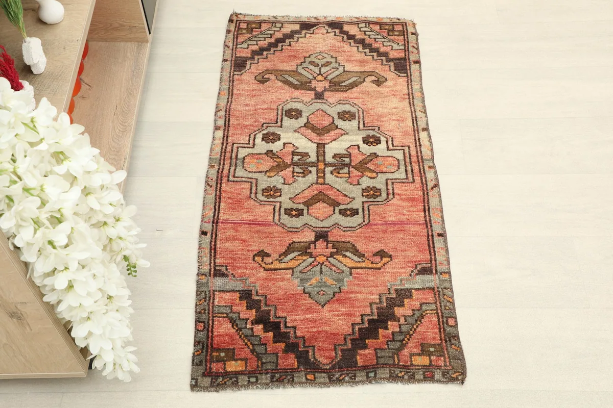 Overhead view of the Anatolian doormat, showcasing its rose field and central geometric design.