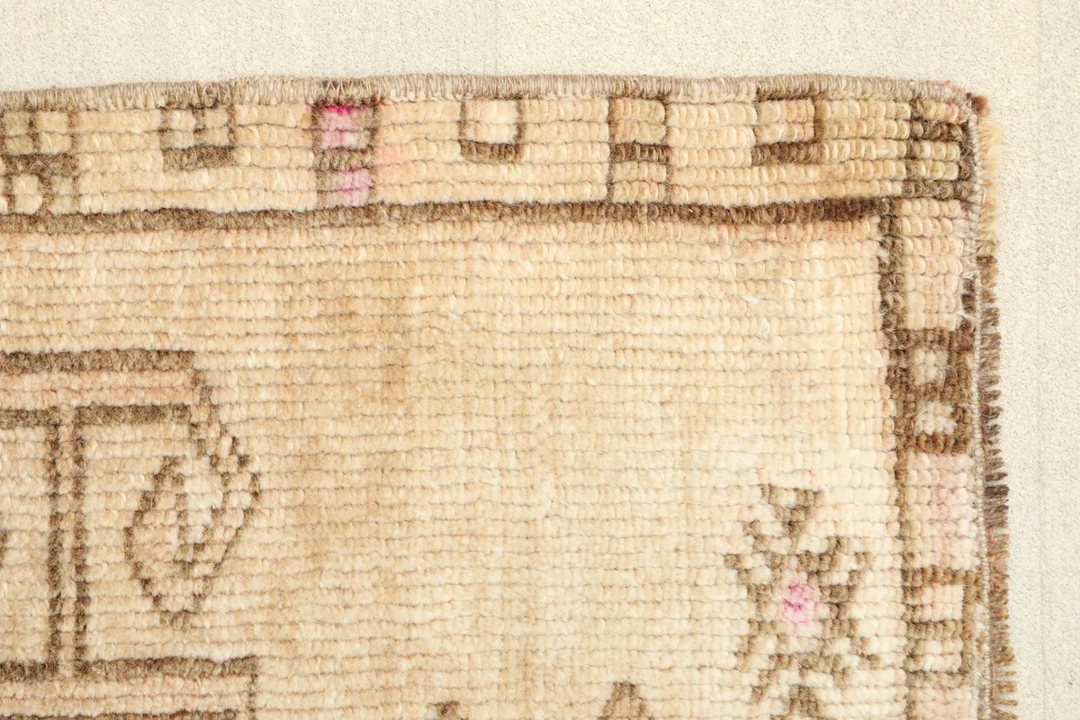 Close-up of the rug's edge, revealing the texture and subtle color variations in the border.