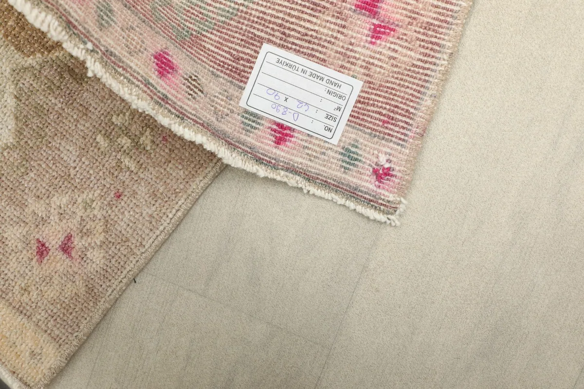 Detailed view of the rug's reverse side, revealing the tight hand-knotted cotton foundation.