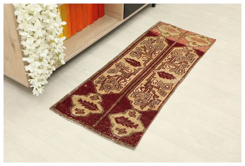 Full overhead view of the red and tan vintage Anatolian doormat