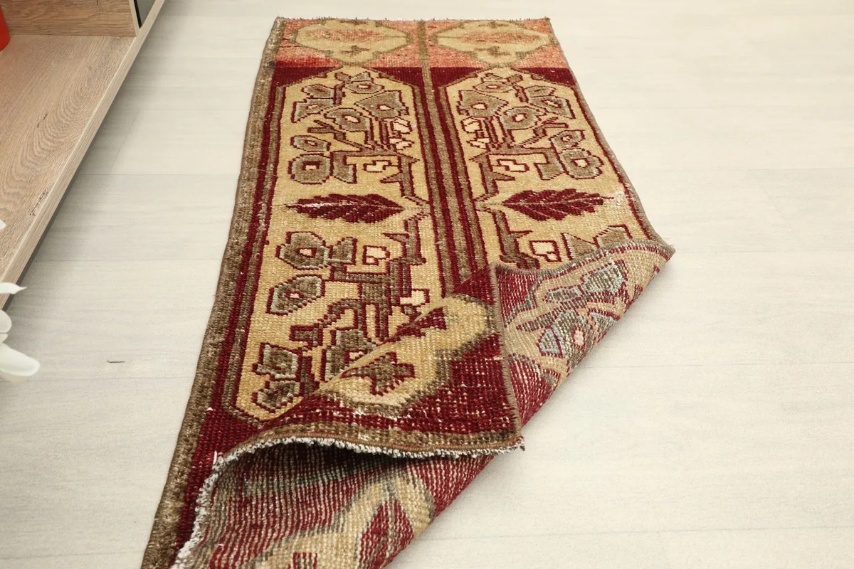 Angled view of the rug partially folded, showing its size in a room setting
