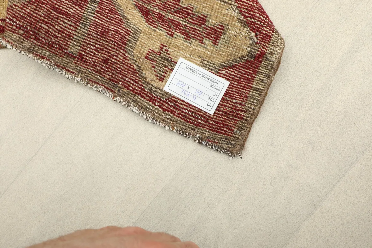Underside of the hand-knotted rug showing the cotton foundation