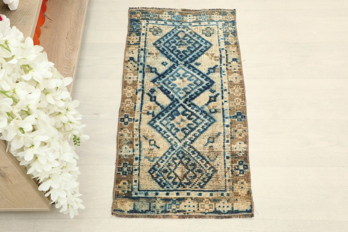 Overhead view of the 1'5" x 2'8" hand-knotted wool rug, showing its rectangular shape and colors.