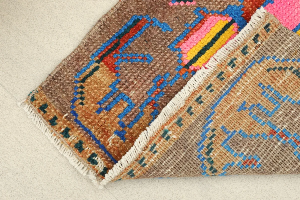 View of the rug's back, revealing the cotton foundation and the reverse of the hand-knotted construction.