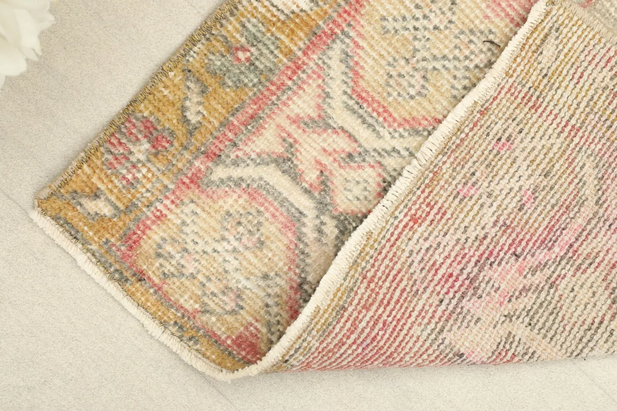 View of the rug's pile and cotton foundation from a folded corner