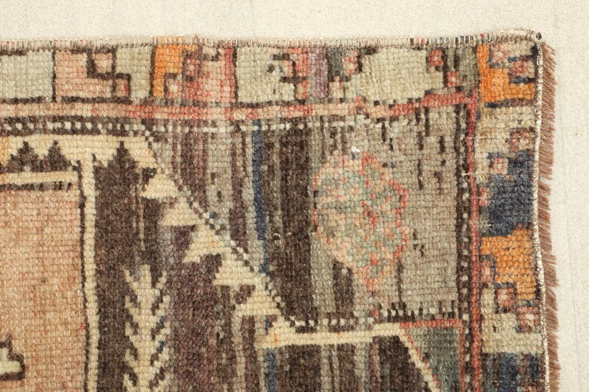 Detailed view of the rug's edge, highlighting the varying pile and color transitions.