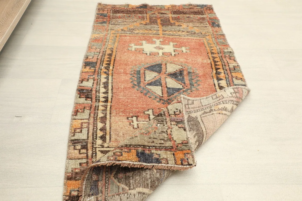 Overhead view of the rug with one corner folded, showing the flexibility and reverse side.