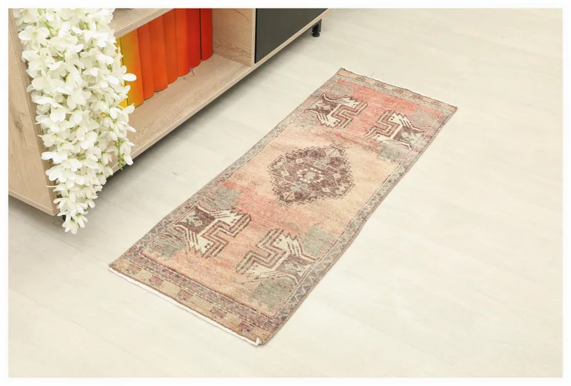 Full top view of the 1'5" x 3'10" vintage Anatolian runner with beige and rust tones
