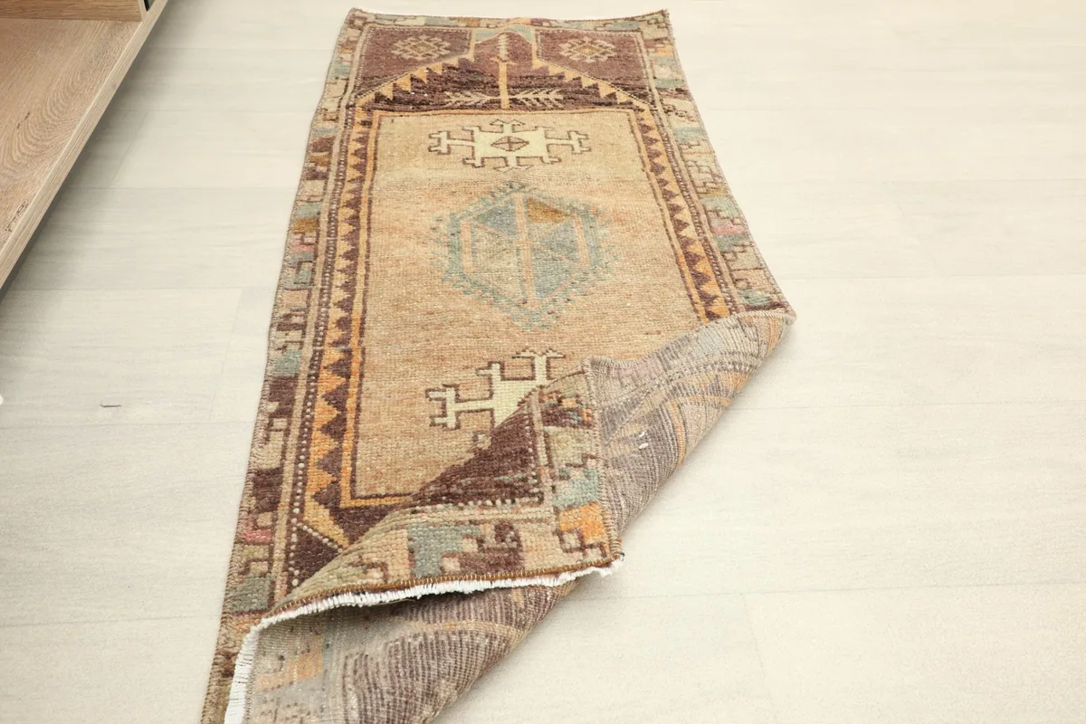 Runner rug placed in a room setting, partially folded to show its flexibility and size.