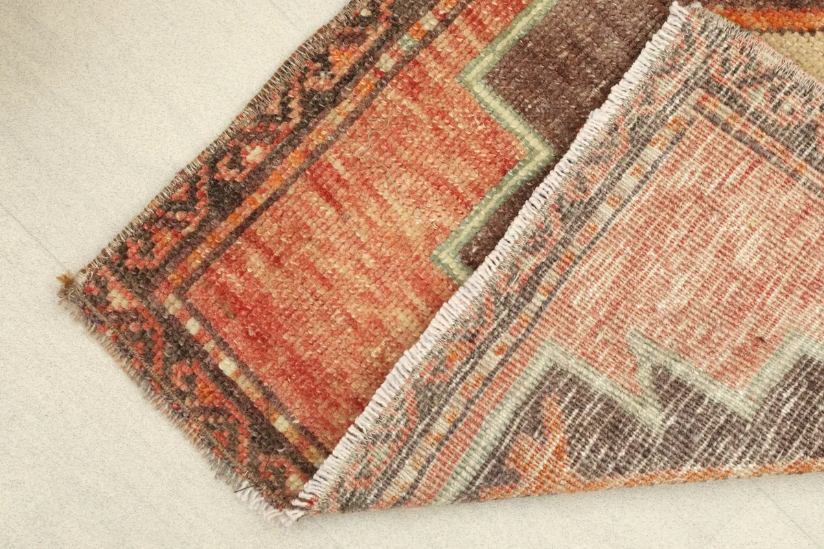 The rug folded to show the flexibility and texture of the vintage wool pile.