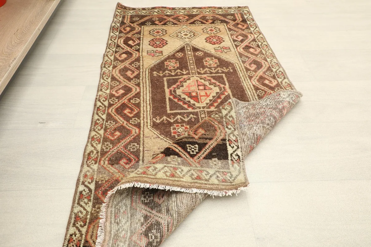 The rug partially folded, illustrating its flexibility and construction
