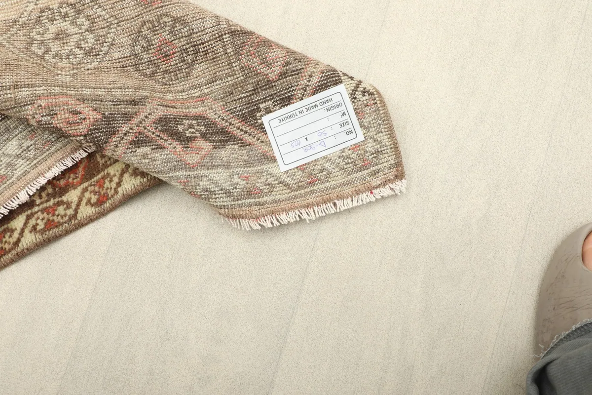 View of the rug's back with a label, showing the craftsmanship