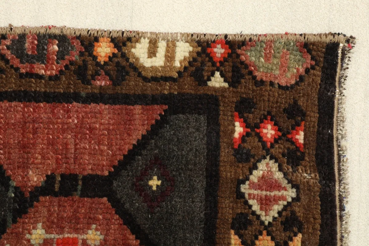 Another corner view, focusing on the intricate brown border and the transition to the charcoal field.