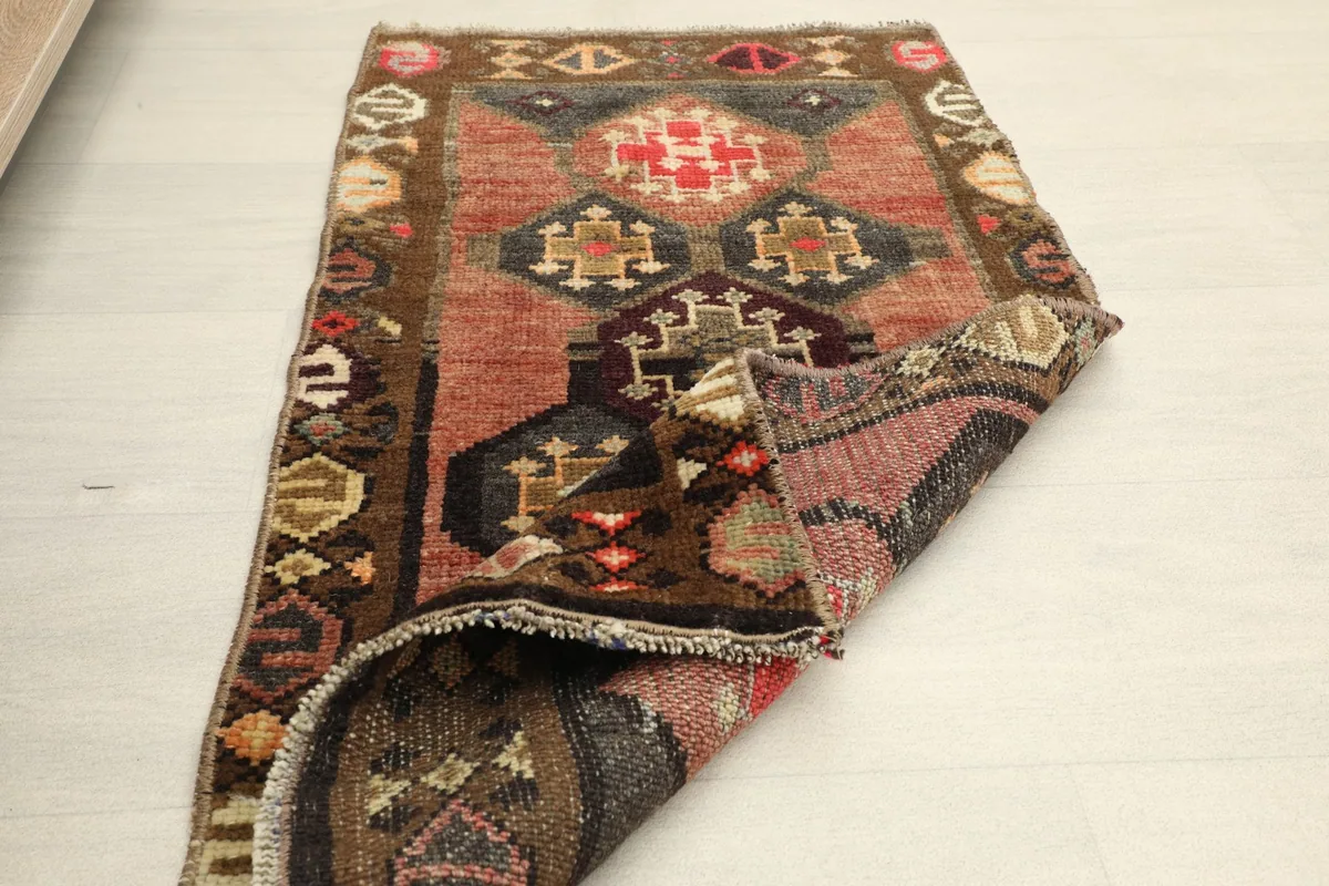 The rug partially folded, illustrating its flexibility and the overall design from an angle.